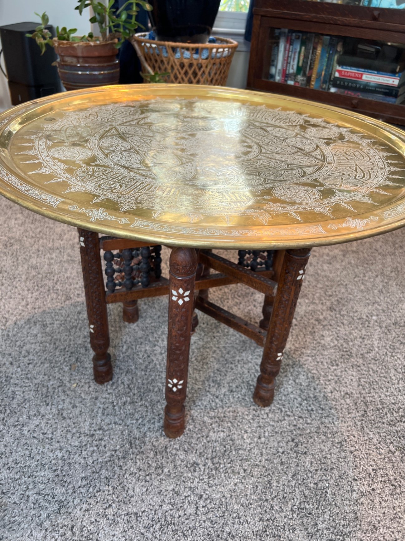 Round brass engraved tray/table with carved wooden chair frame, and red patterned rug - image 1 of 11