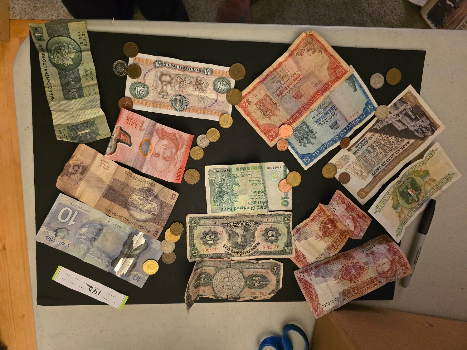 Assorted international banknotes and coins - image 1 of 14