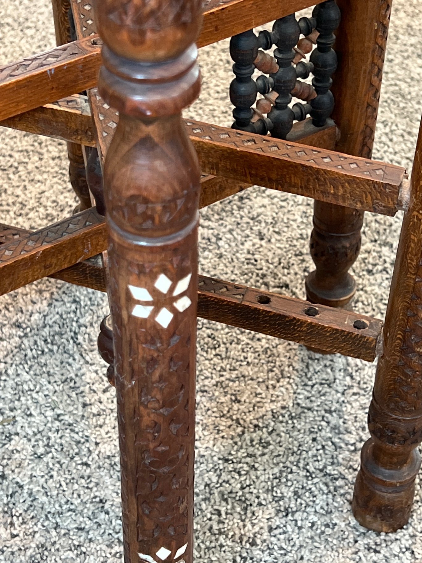 Round brass engraved tray/table with carved wooden chair frame, and red patterned rug - image 5 of 11