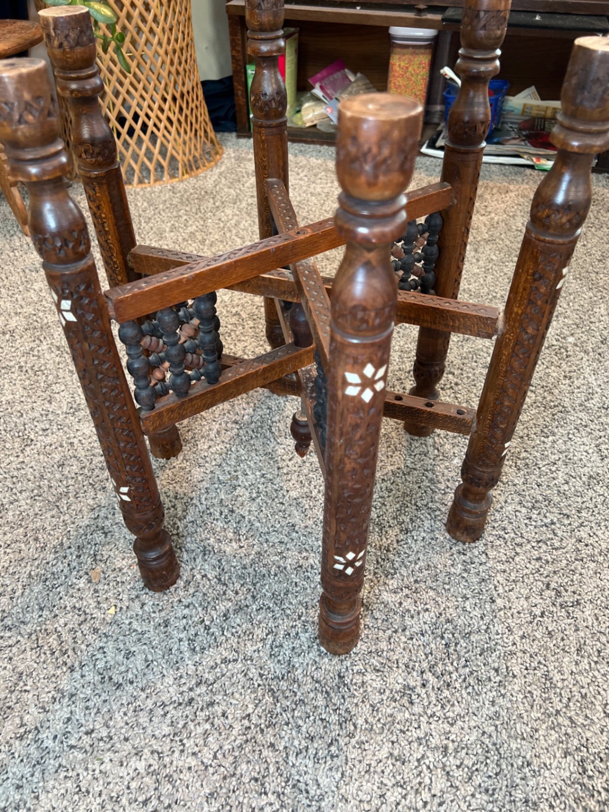 Round brass engraved tray/table with carved wooden chair frame, and red patterned rug - image 4 of 11
