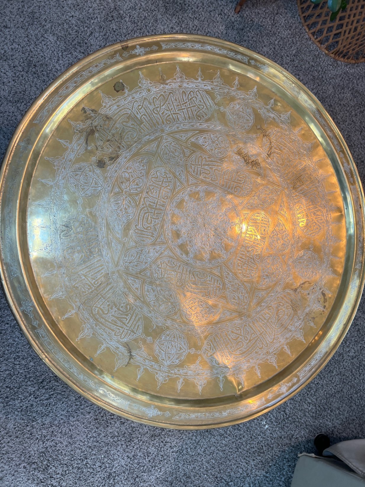 Round brass engraved tray/table with carved wooden chair frame, and red patterned rug - image 3 of 11