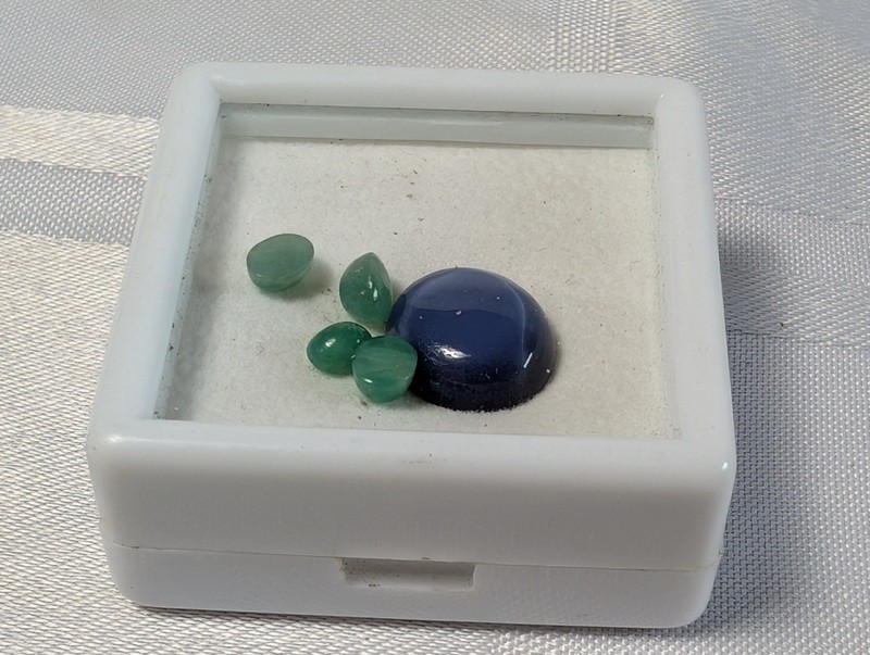 Green teardrop gemstones and a blue cabochon in display box - image 1 of 8
