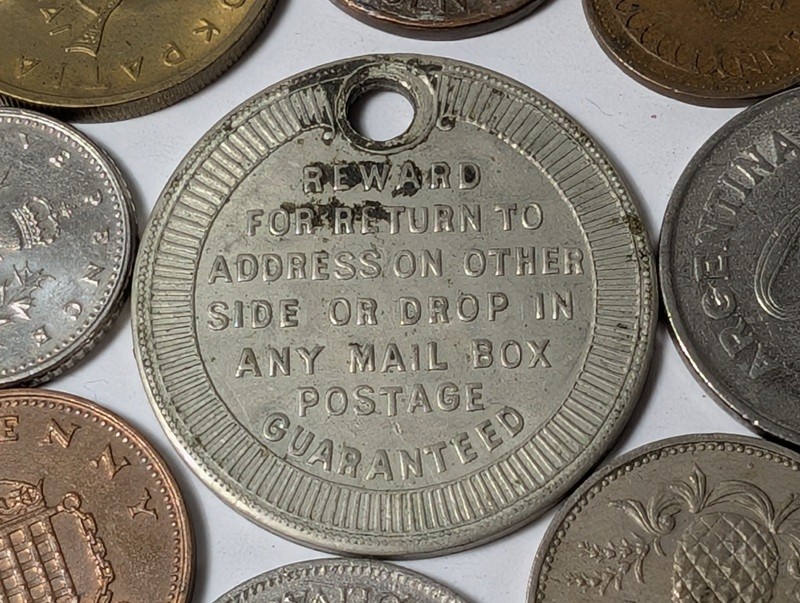 Assorted international coins and tokens - image 23 of 24