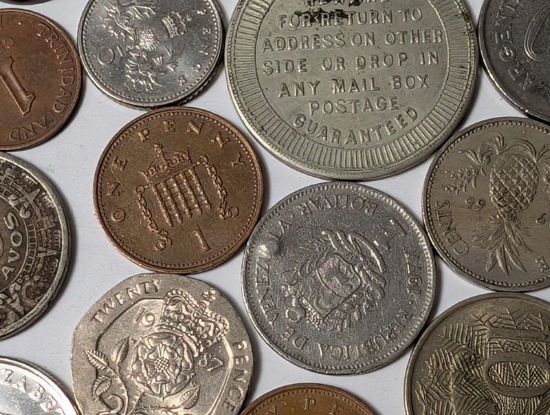 Assorted international coins and tokens - image 19 of 24