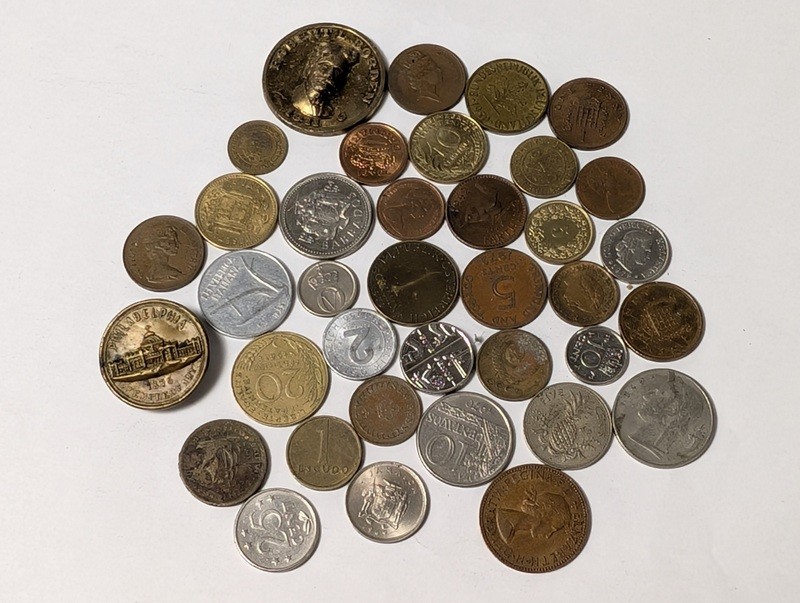 Assorted international coins and tokens - image 1 of 28