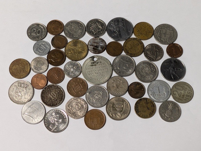 Assorted international coins and tokens - image 1 of 24