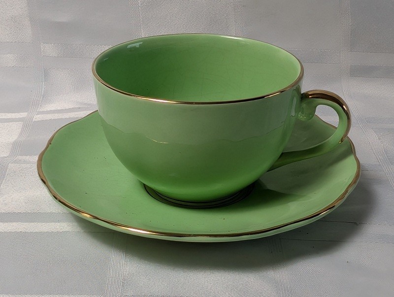Green teacup and saucer set with gold trim - image 1 of 9