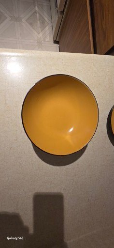 Stack of yellow-inside, black-outside bowls with kitchenware and tea box - image 2 of 8