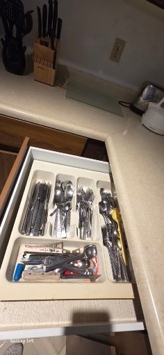 Stack of yellow-inside, black-outside bowls with kitchenware and tea box - image 6 of 8