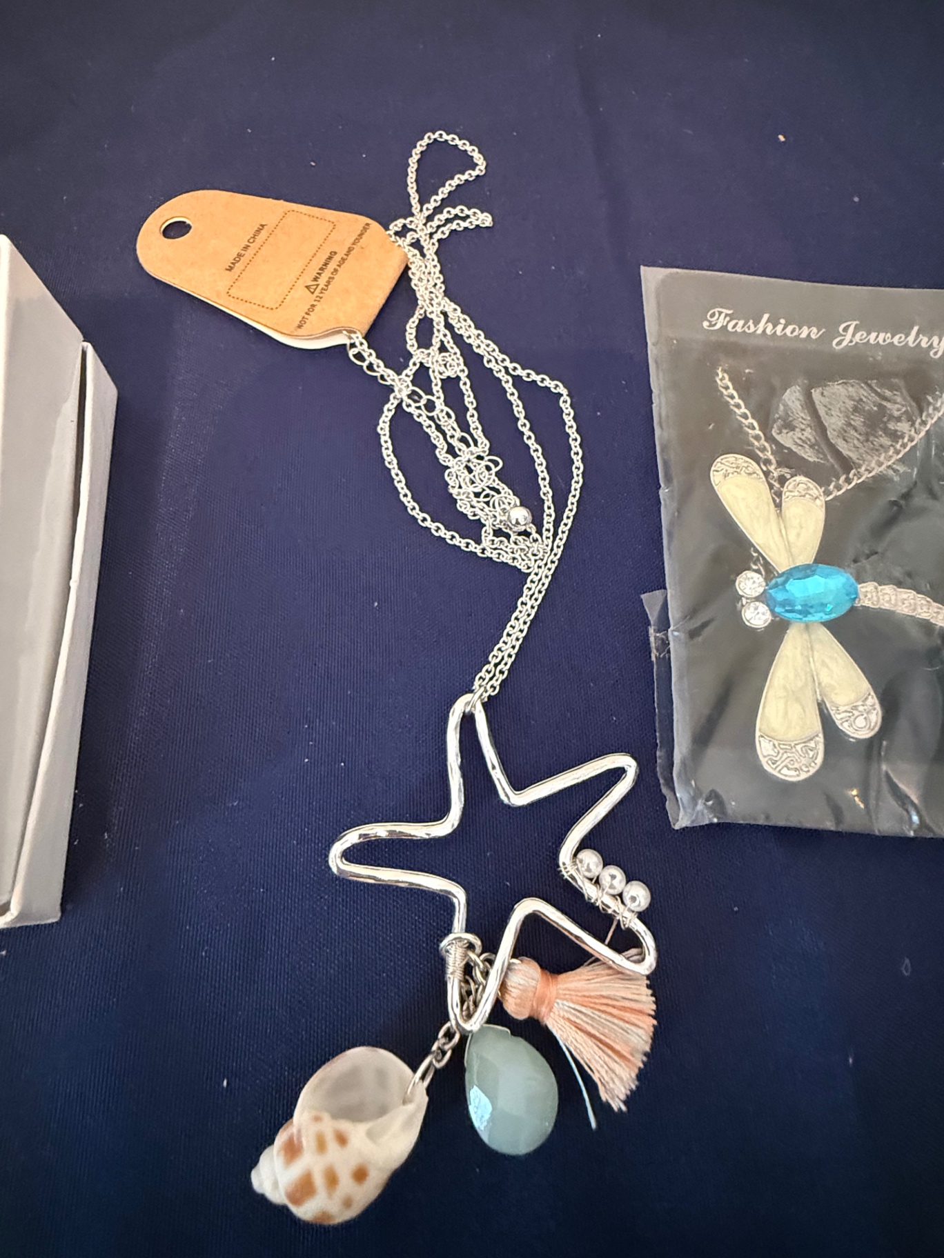 Assorted fashion jewelry: sailboat pendant, dragonfly brooch, and shell charms - image 3 of 4