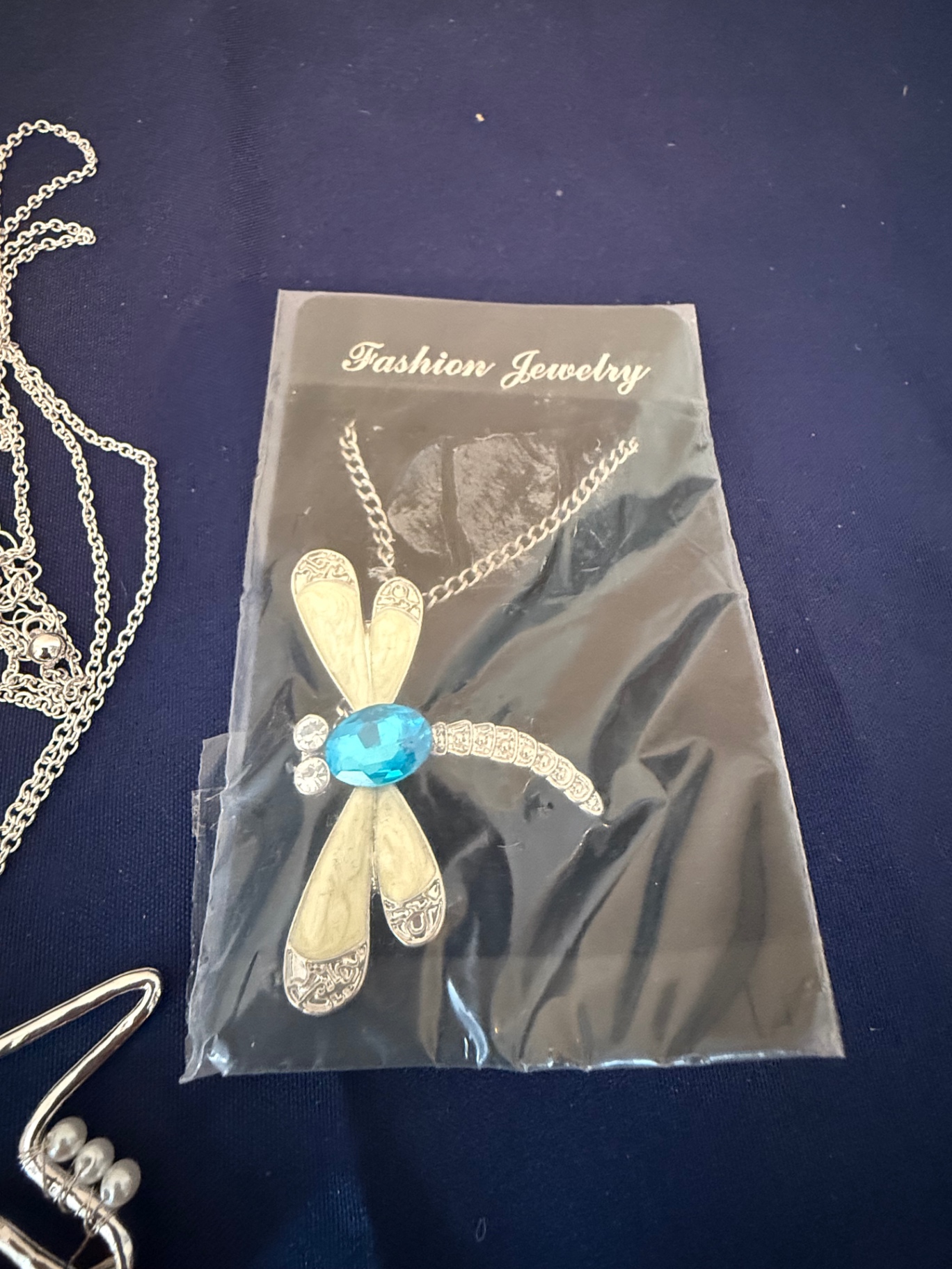 Assorted fashion jewelry: sailboat pendant, dragonfly brooch, and shell charms - image 4 of 4