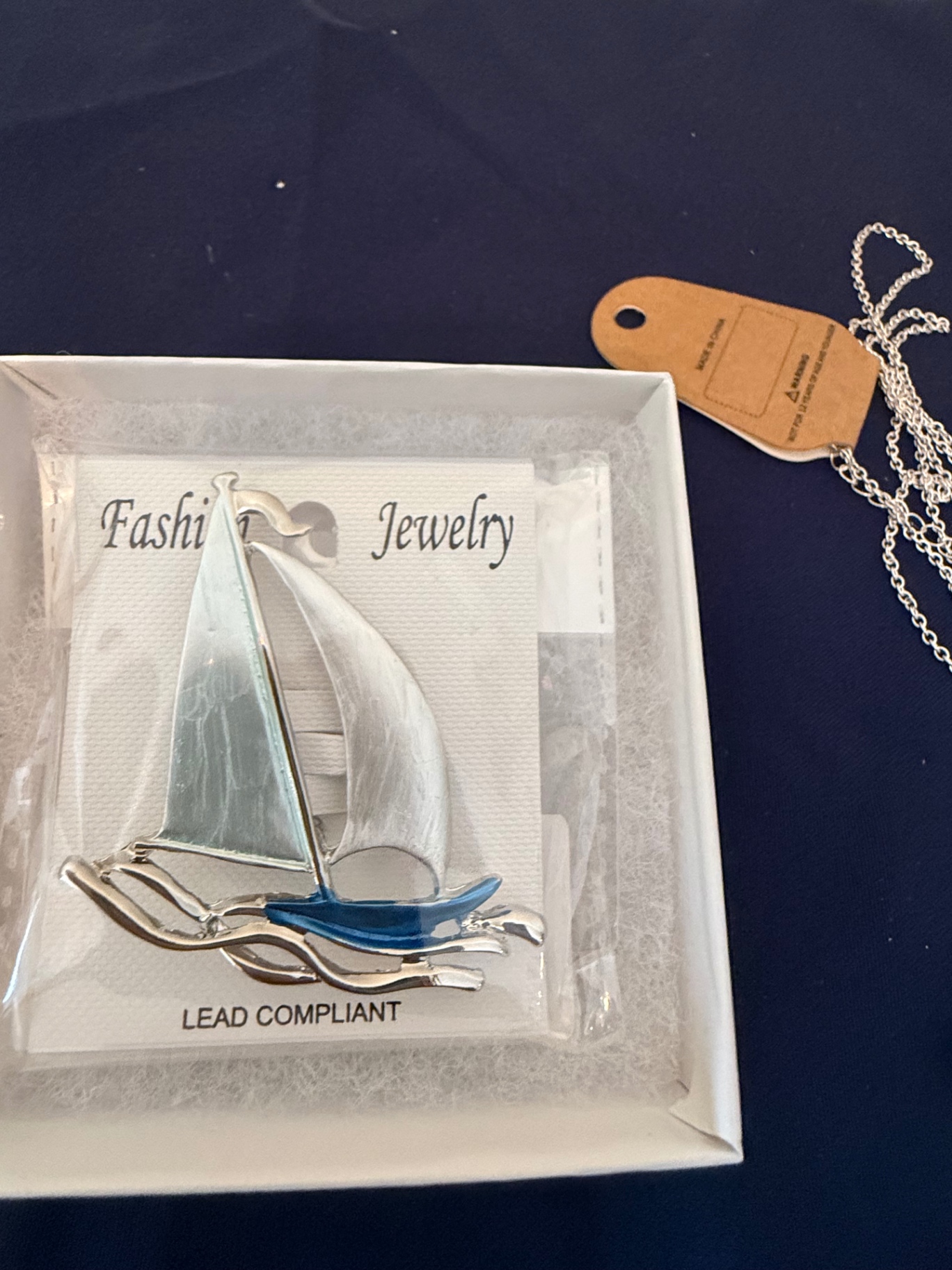 Assorted fashion jewelry: sailboat pendant, dragonfly brooch, and shell charms - image 2 of 4