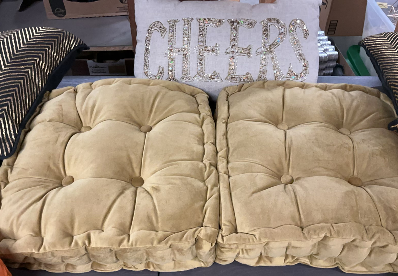 Beige tufted cushions with chevron pillows and orange candle holder - image 2 of 4