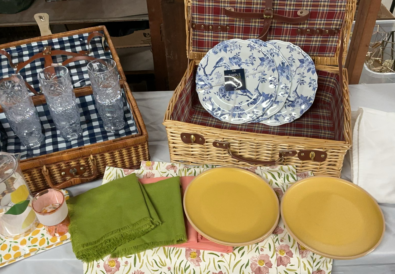 Wicker picnic baskets with blue floral and yellow dinnerware, glassware, and linens - image 1 of 12