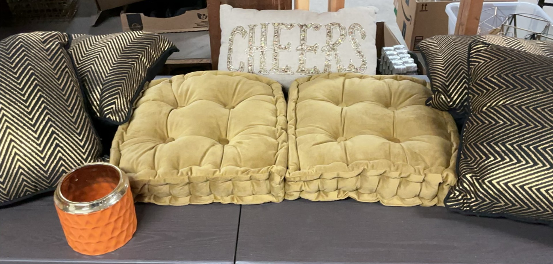 Beige tufted cushions with chevron pillows and orange candle holder - image 1 of 4
