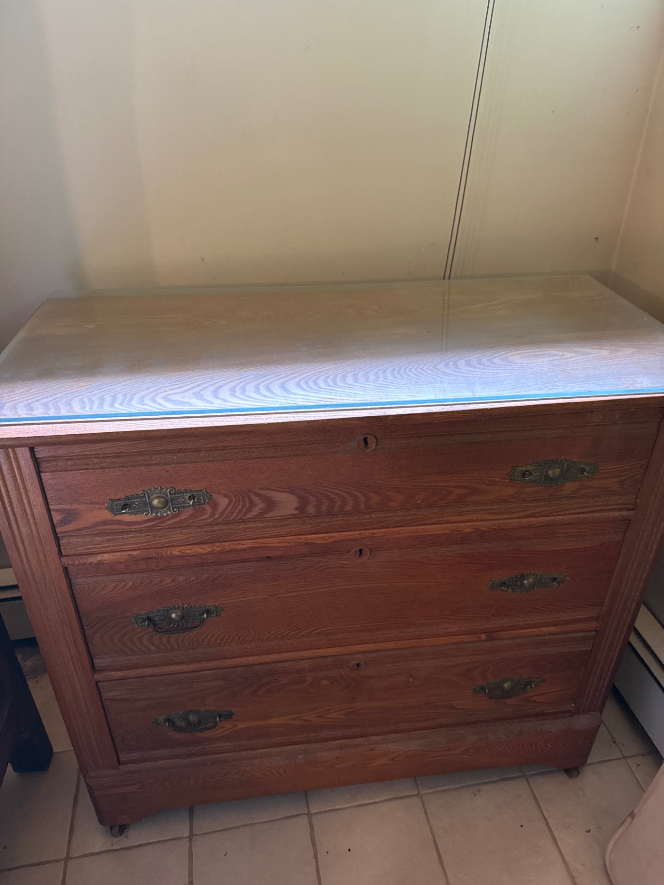 Wooden dresser with glass top and three drawers - image 1 of 3