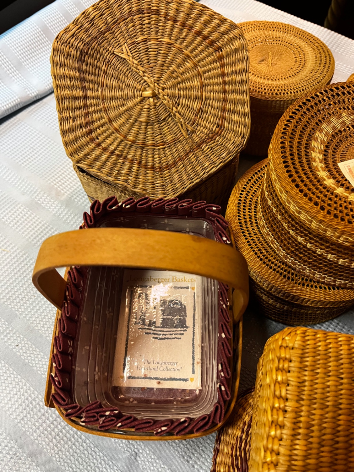 An assortment of small woven baskets and a small Longaberger handled basket - image 2 of 3