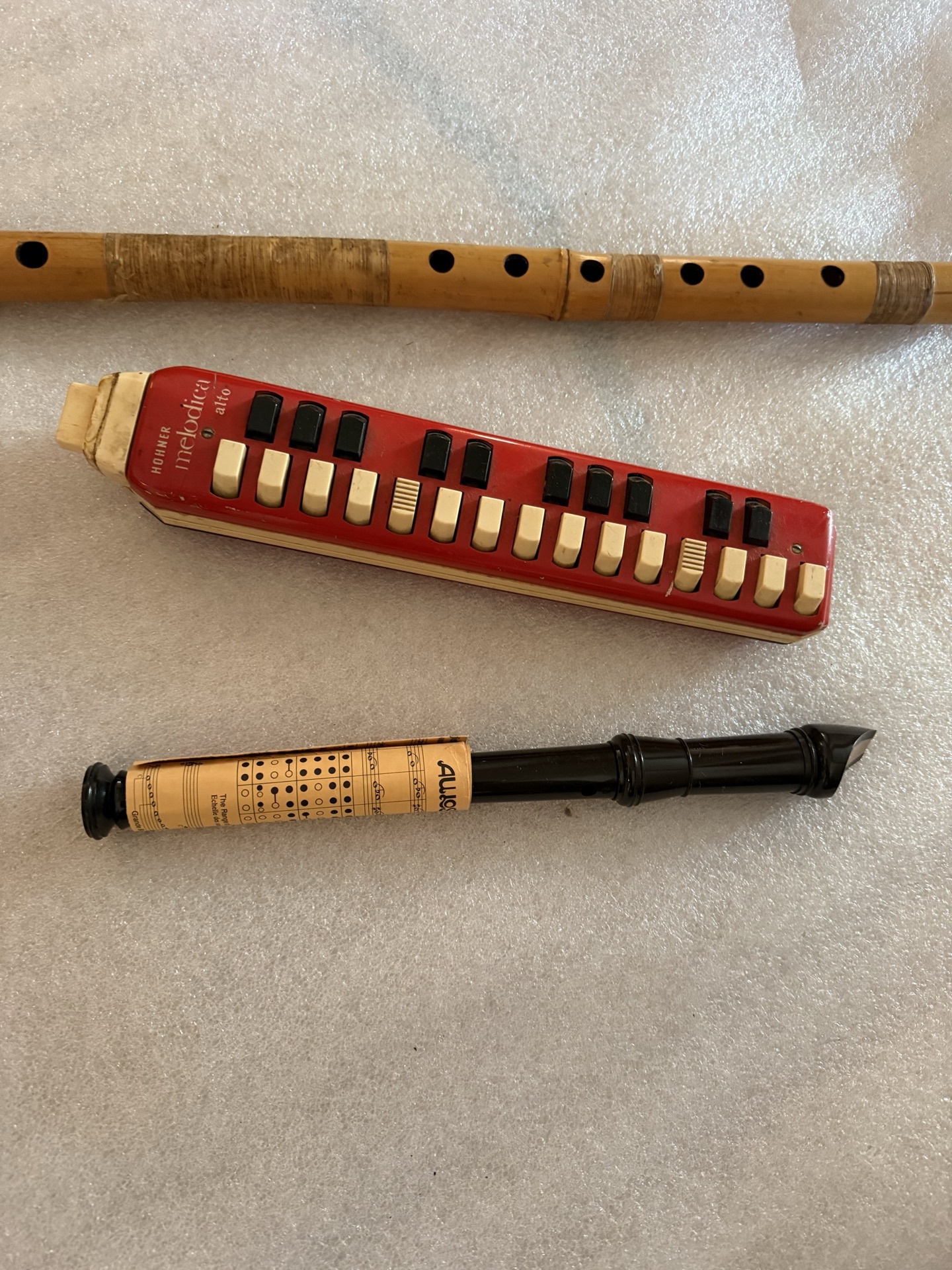Red Hohner melodica, wooden recorder, and black  wind instrument - image 1 of 5