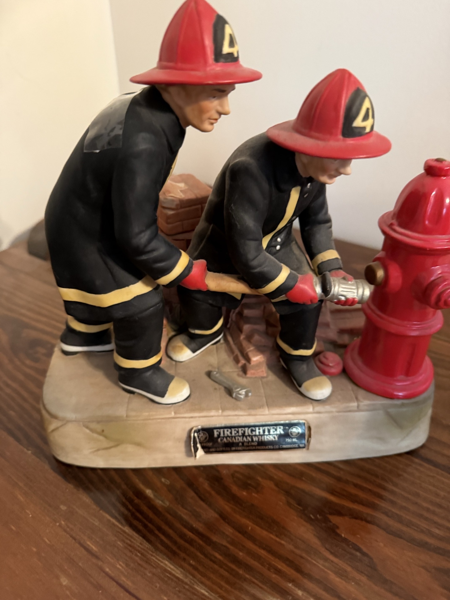 Firefighter figurine sculpture with hydrant and brick wall - image 1 of 4