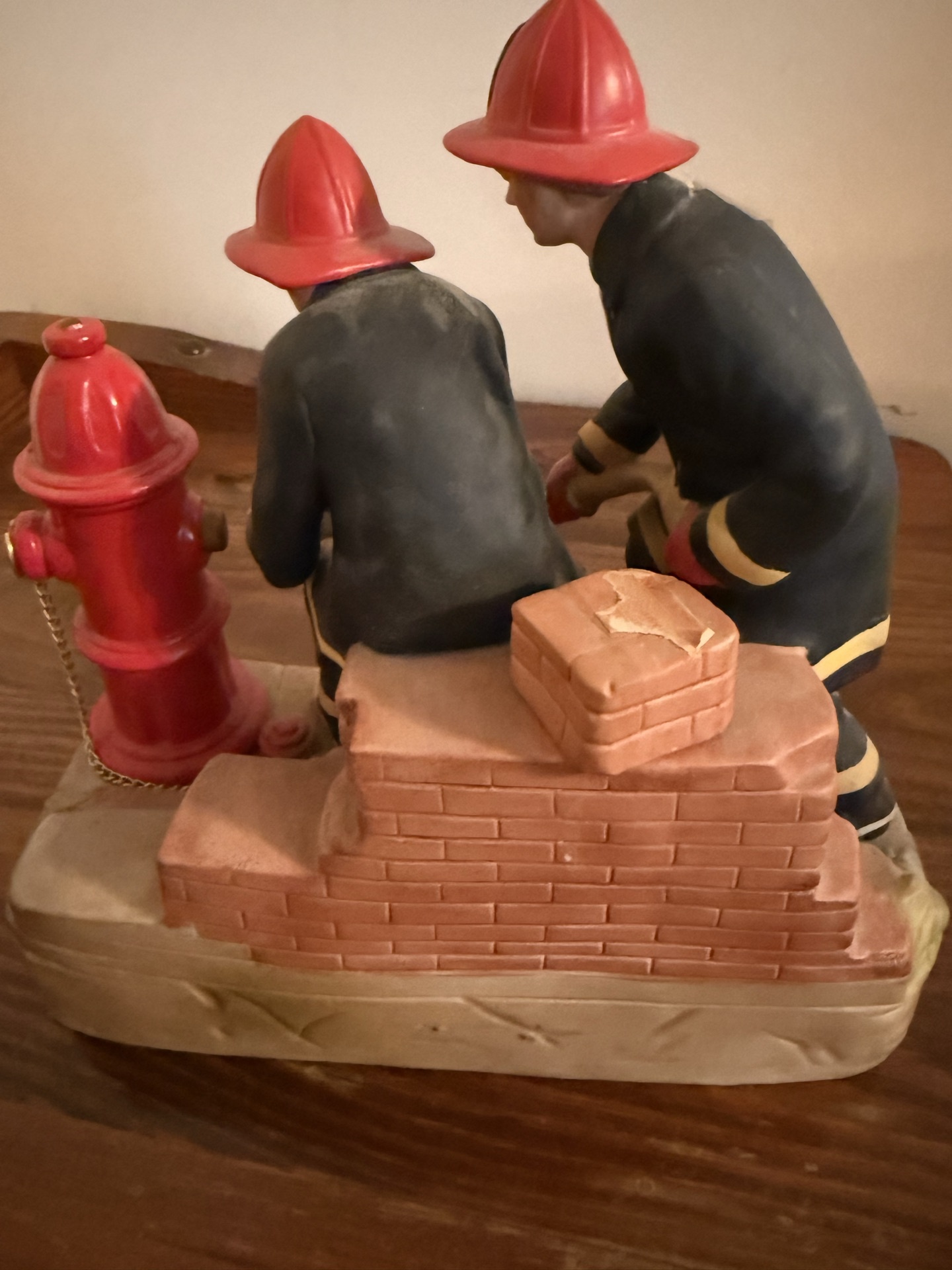 Firefighter figurine sculpture with hydrant and brick wall - image 3 of 4