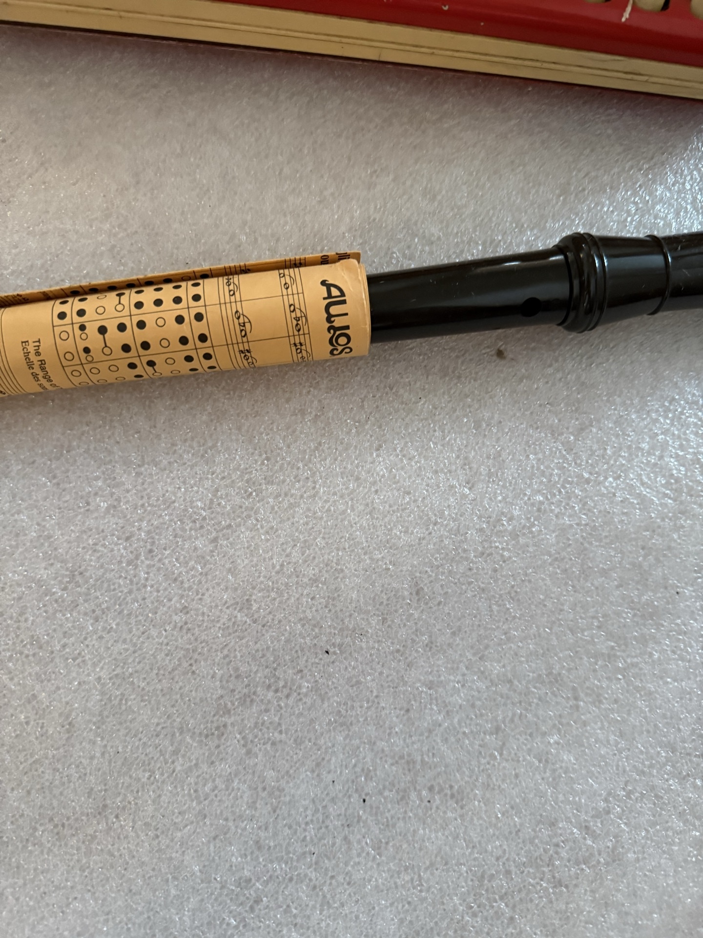 Red Hohner melodica, wooden recorder, and black  wind instrument - image 2 of 5