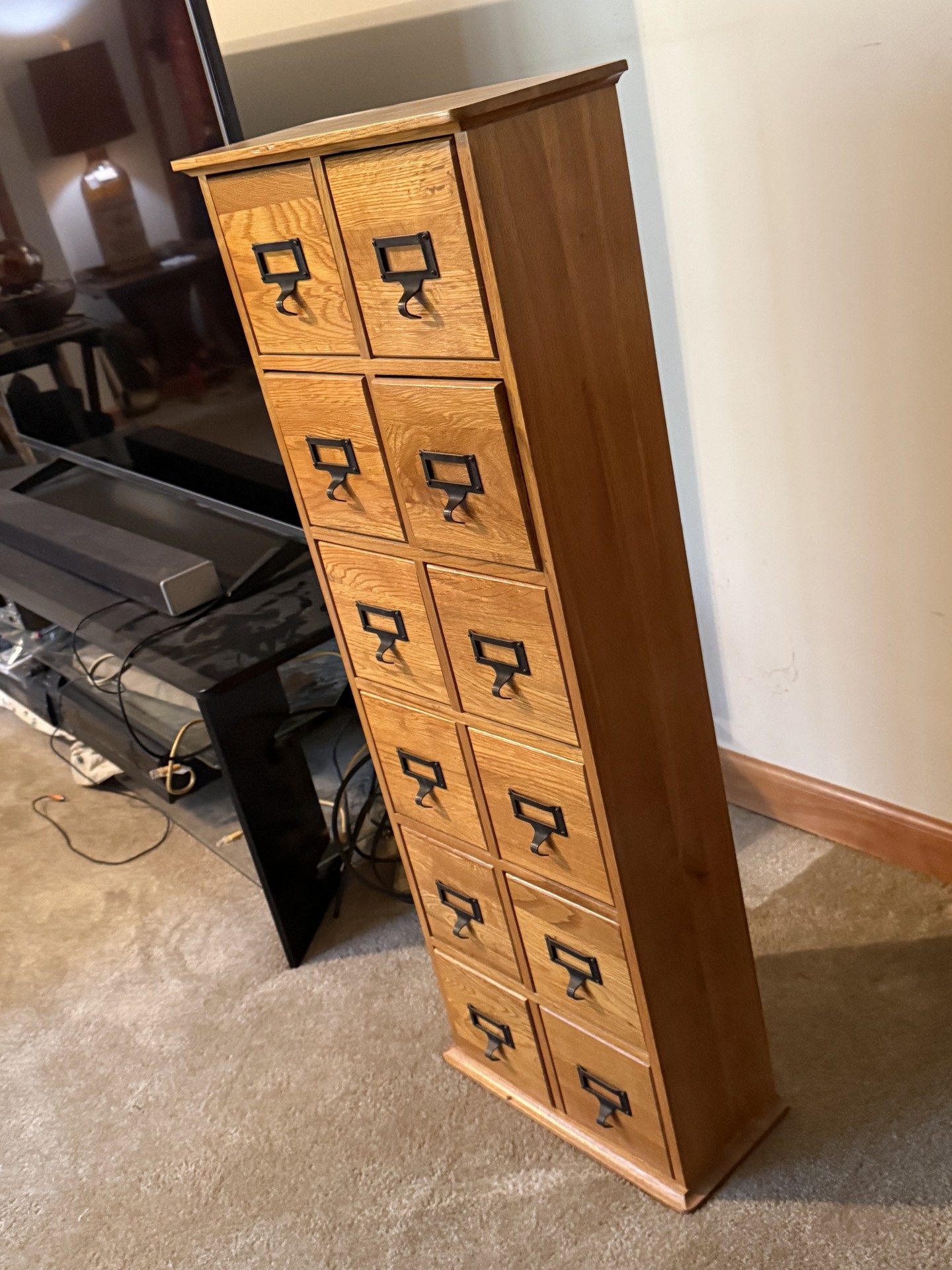 Oak-finished tall cabinet with multiple small drawers - image 1 of 12