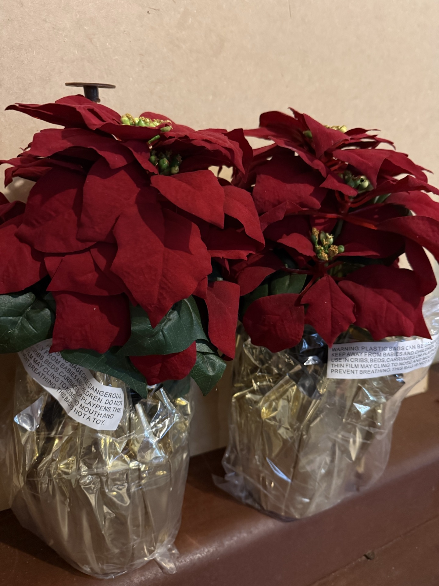 Three red poinsettia plants in plastic-wrapped pots - image 3 of 4