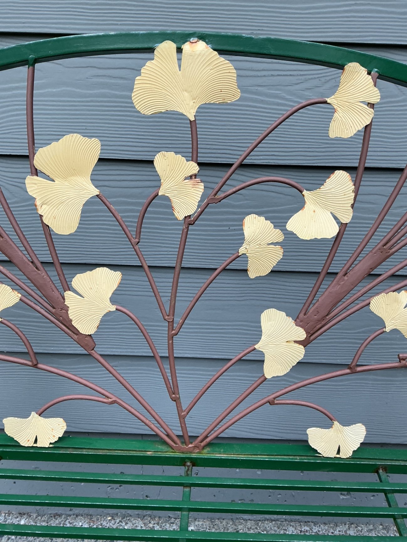 Green metal garden bench with leaf motif and large stone planter - image 4 of 6