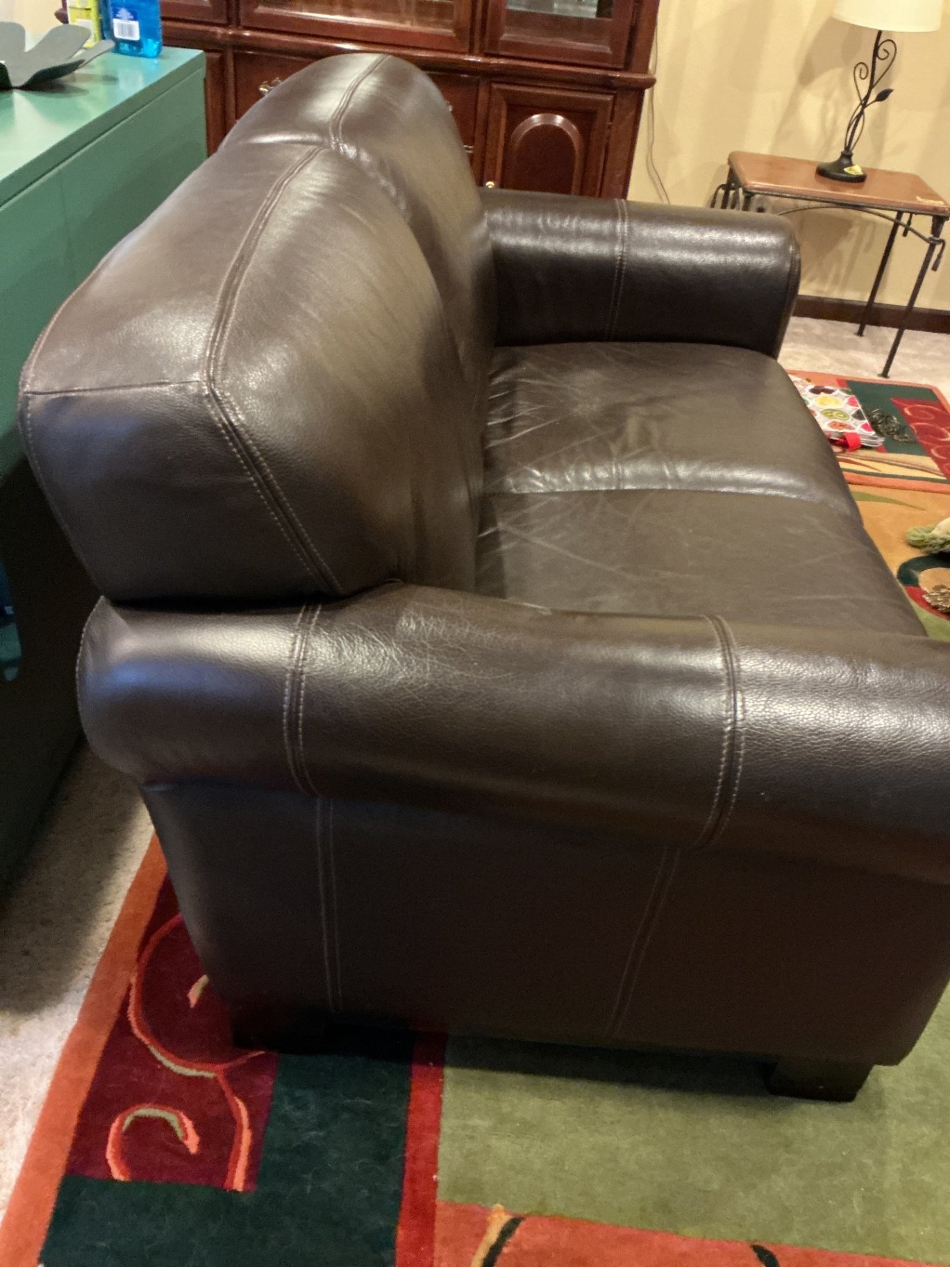 Dark brown leather loveseat with decorative pillows - image 5 of 10