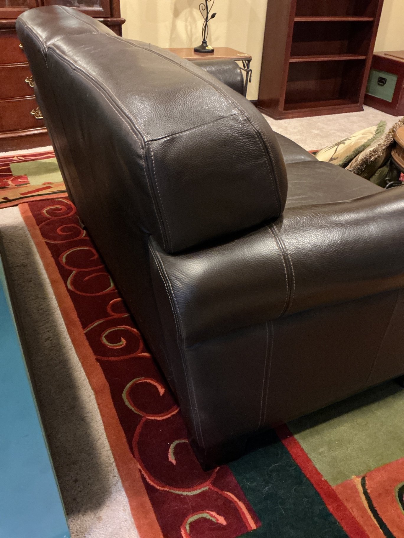 Dark brown leather loveseat with decorative pillows - image 6 of 10