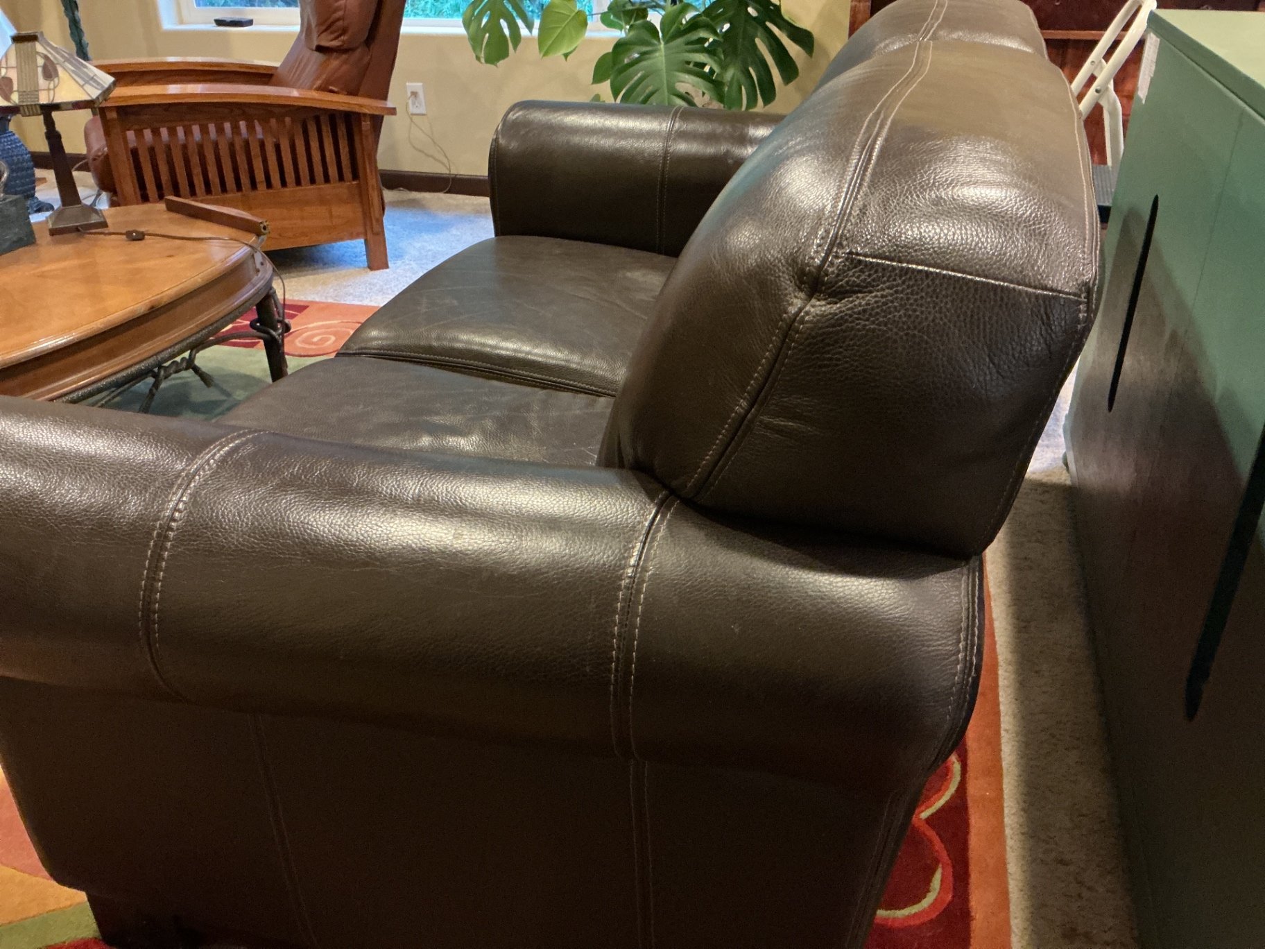 Dark brown leather loveseat with decorative pillows - image 4 of 10