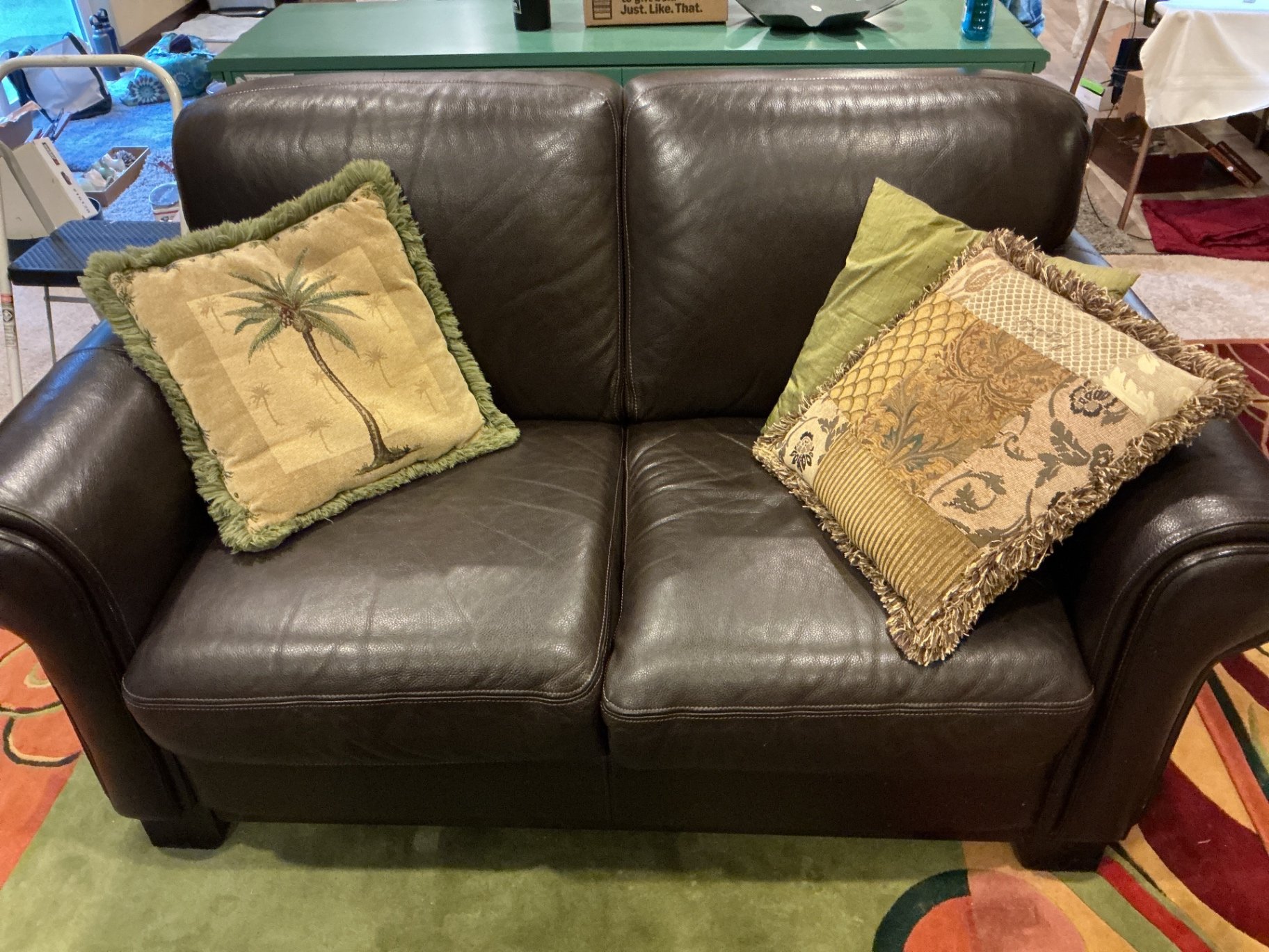 Dark brown leather loveseat with decorative pillows - image 2 of 10