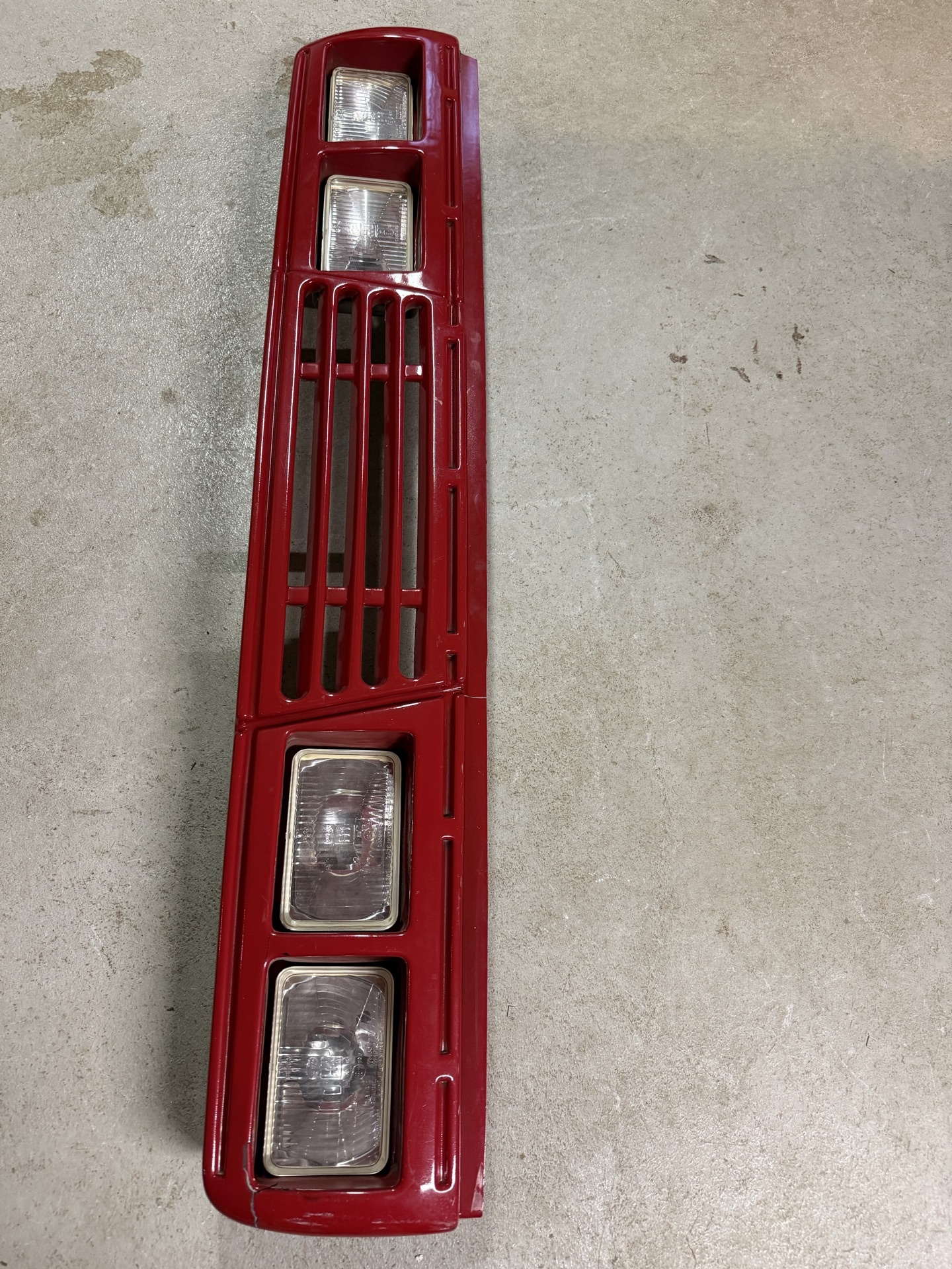 Red front grille with integrated rectangular headlights and related automotive parts - image 1 of 7