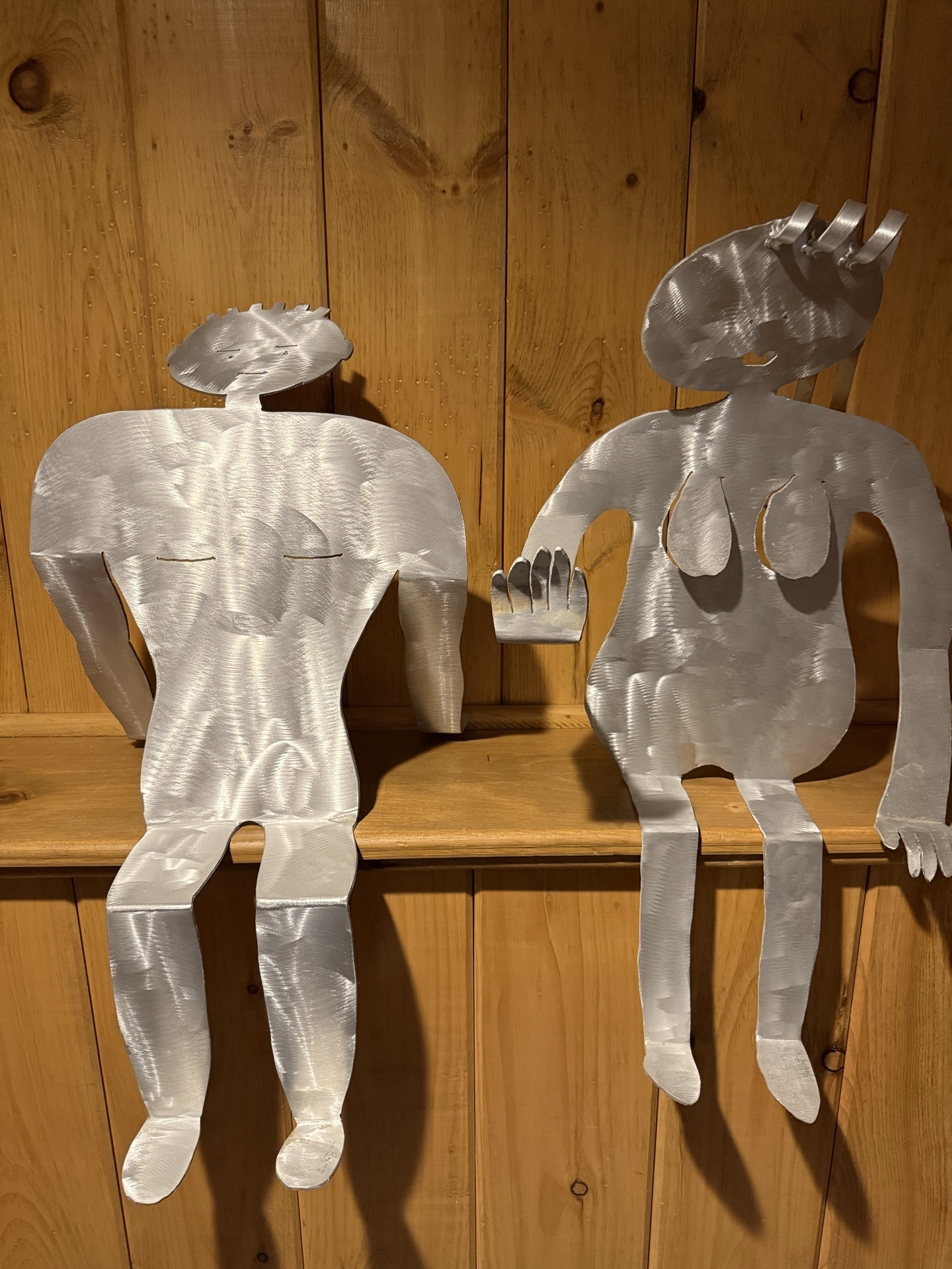 Two metal silhouette sculptures of seated humanoid figures - image 1 of 5