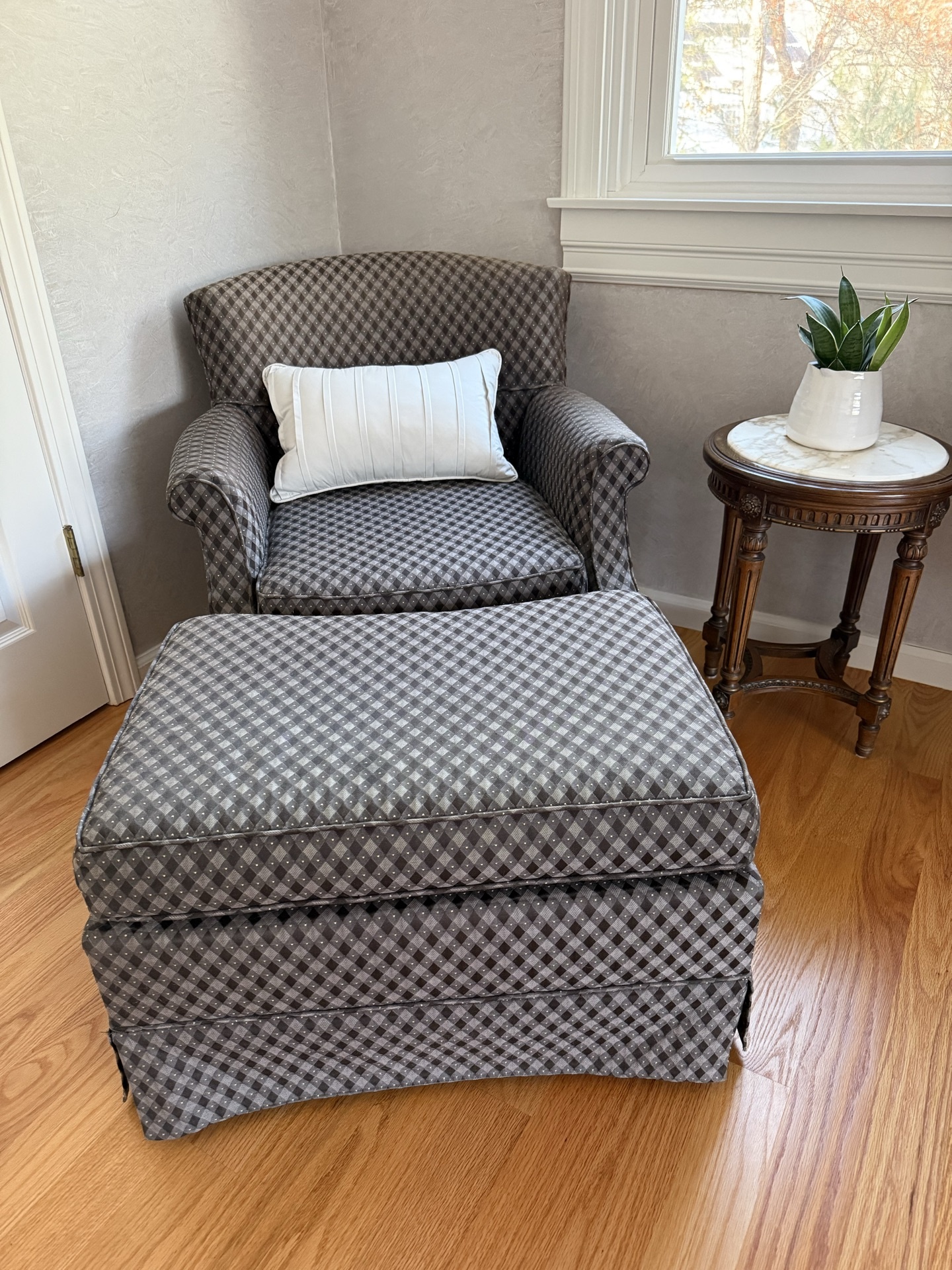 Louis XVI style armchair with ottoman, marble-top side table, and plant - image 1 of 6