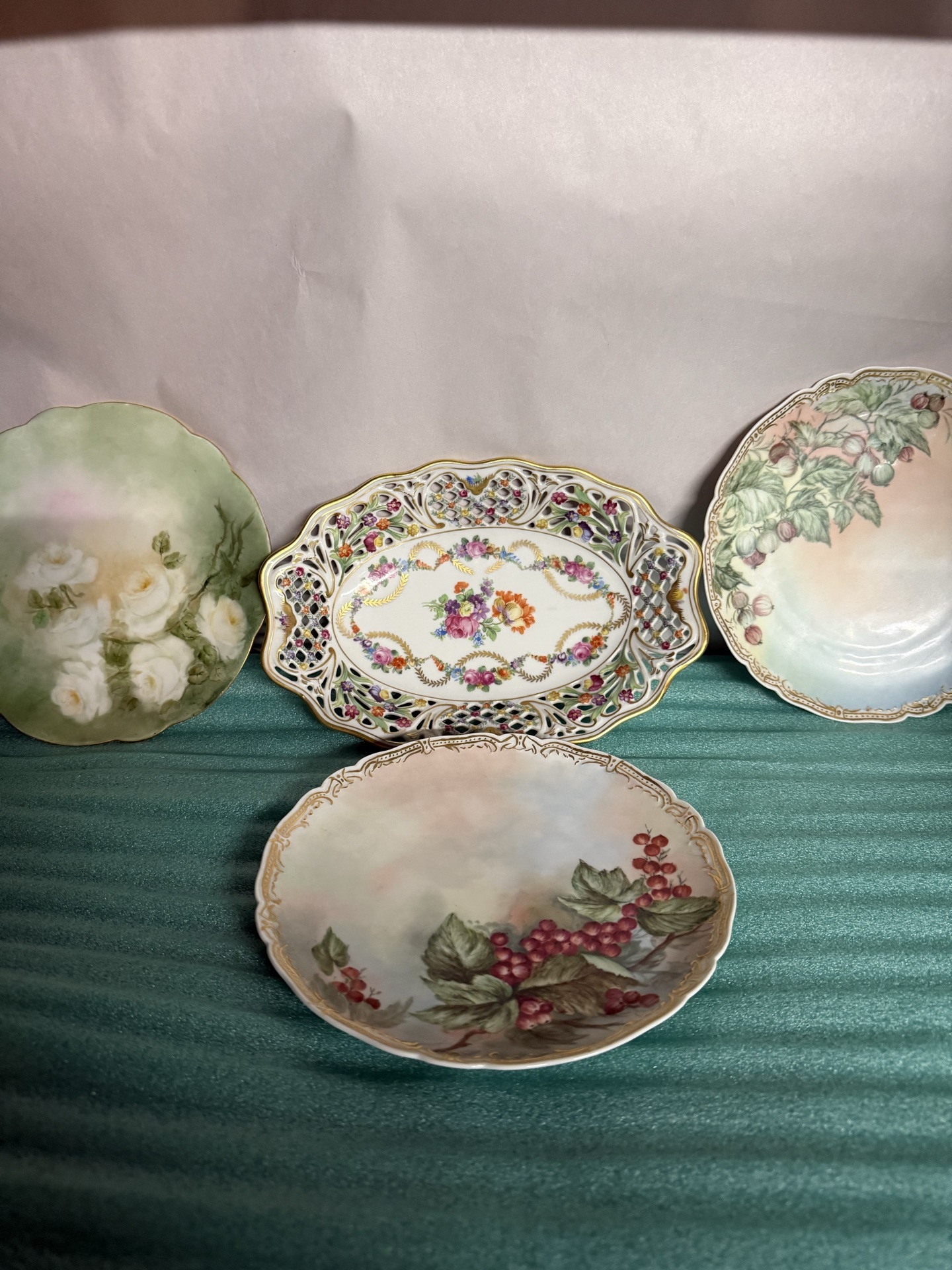 Set of four decorative porcelain plates with floral designs - image 1 of 10