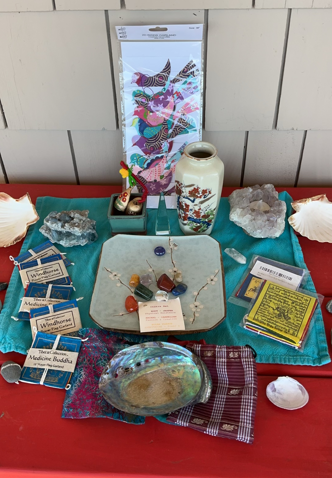 Assorted decorative Altar items: ceramics, artwork, crystals, and Tibetan prayer flags - image 1 of 9