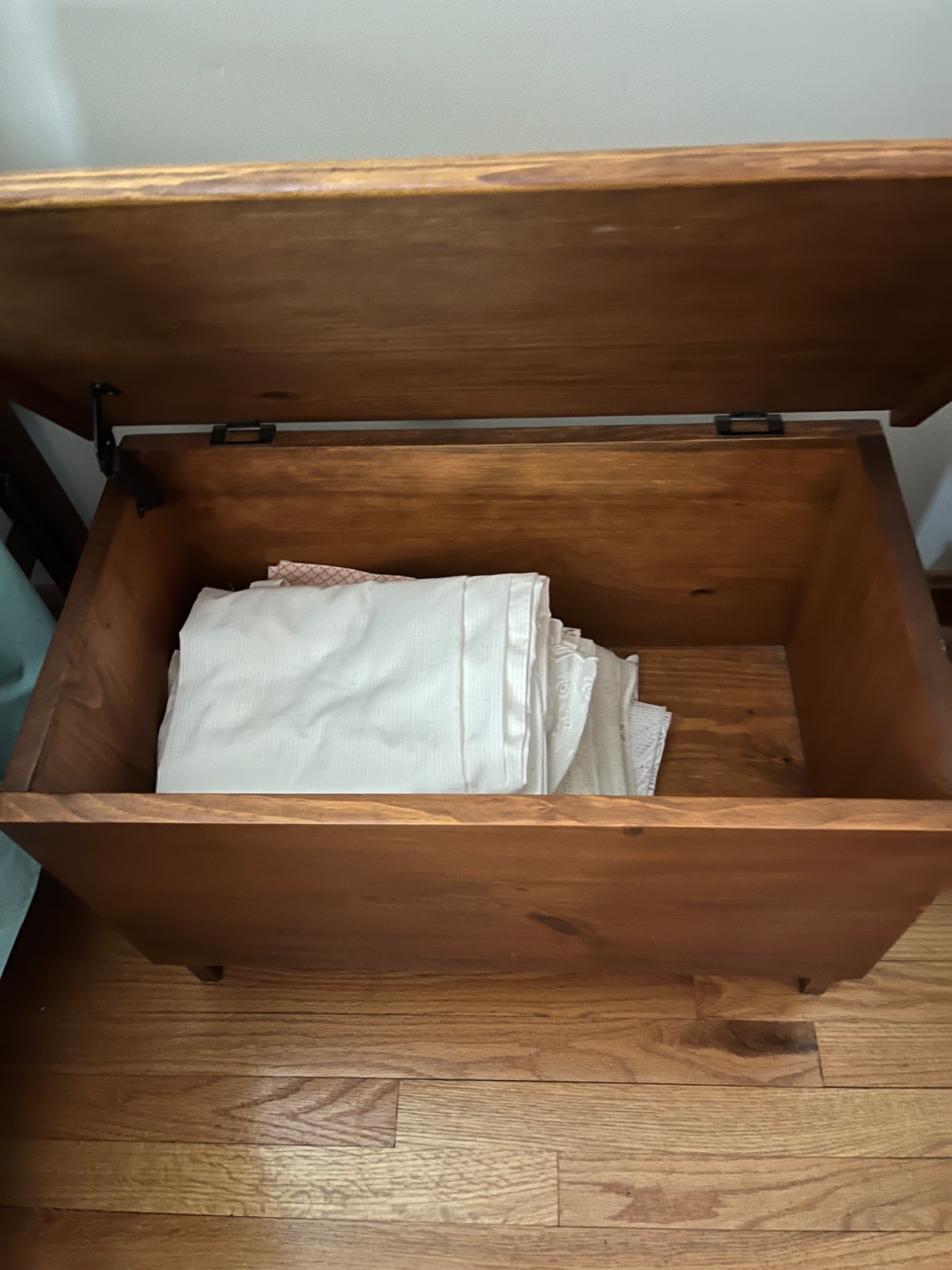 Wooden storage chest with folded linens - image 2 of 2