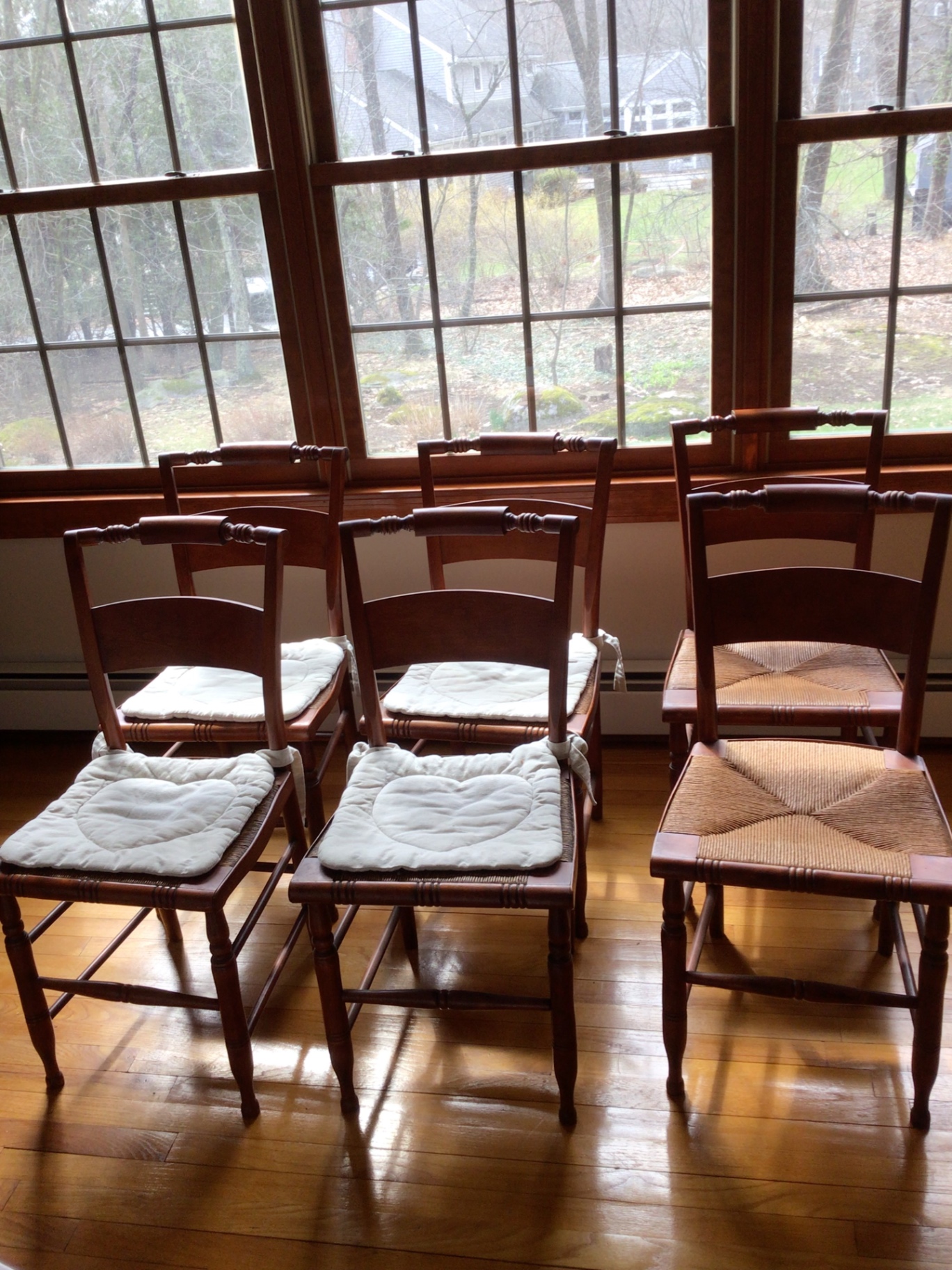 Wooden dining chairs with woven cane seats - image 1 of 6