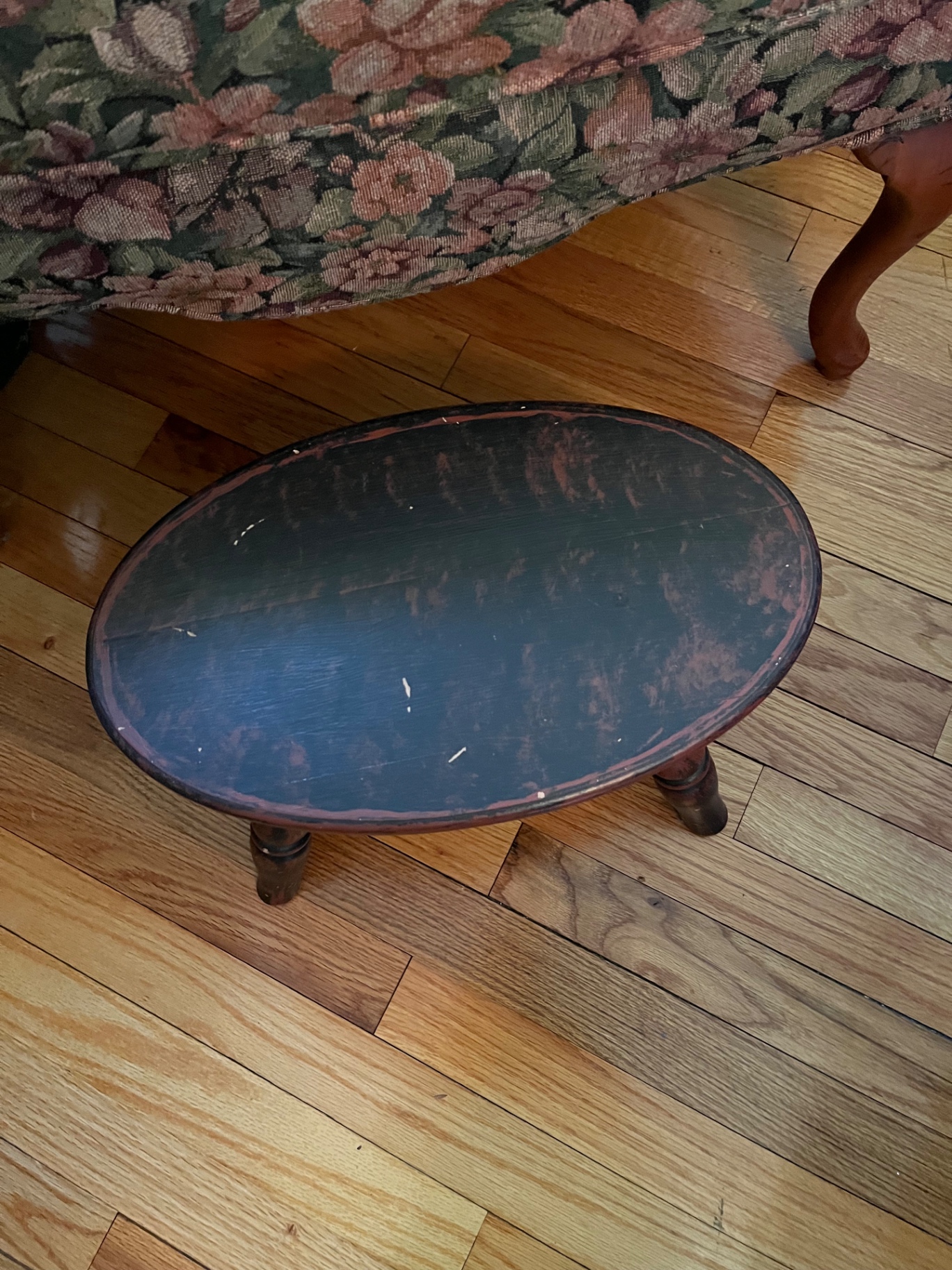Floral patterned wingback armchair and small oval footstool - image 3 of 3