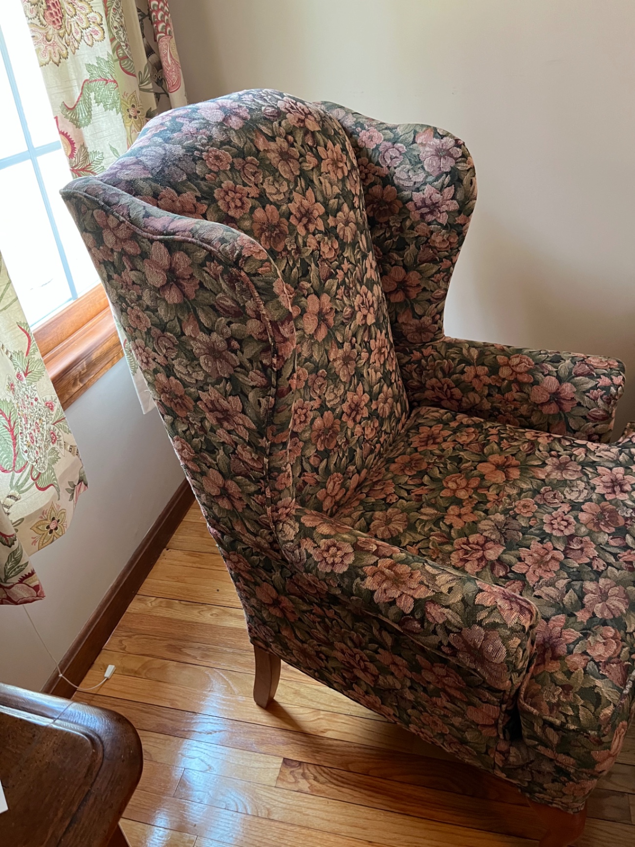Floral patterned wingback armchair and small oval footstool - image 2 of 3