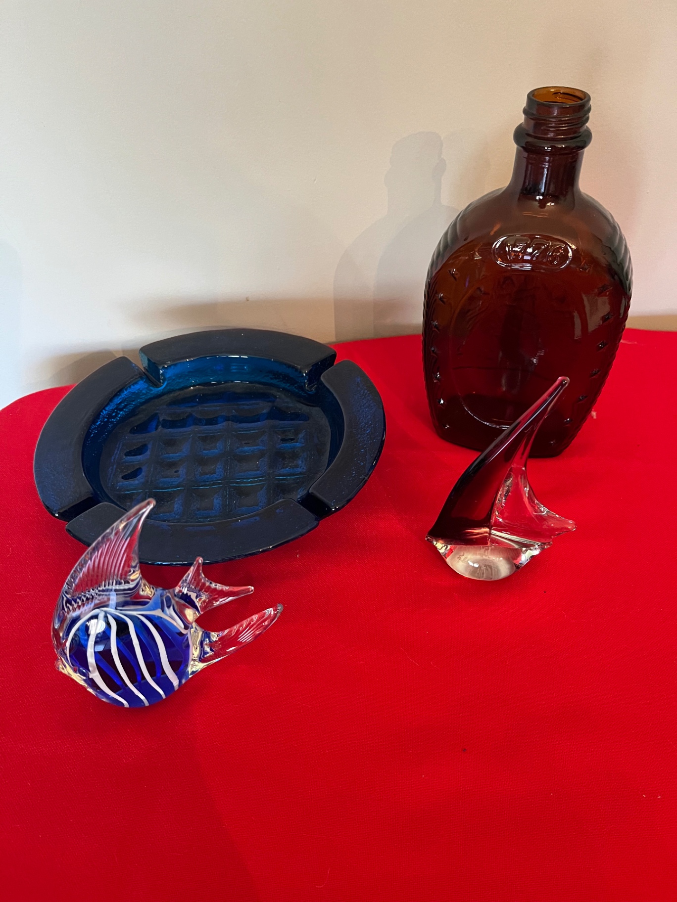 Glass art pieces including blue striped fish, blue ashtray, brown sailboat, brown bottle, and blue ashtray - image 1 of 1