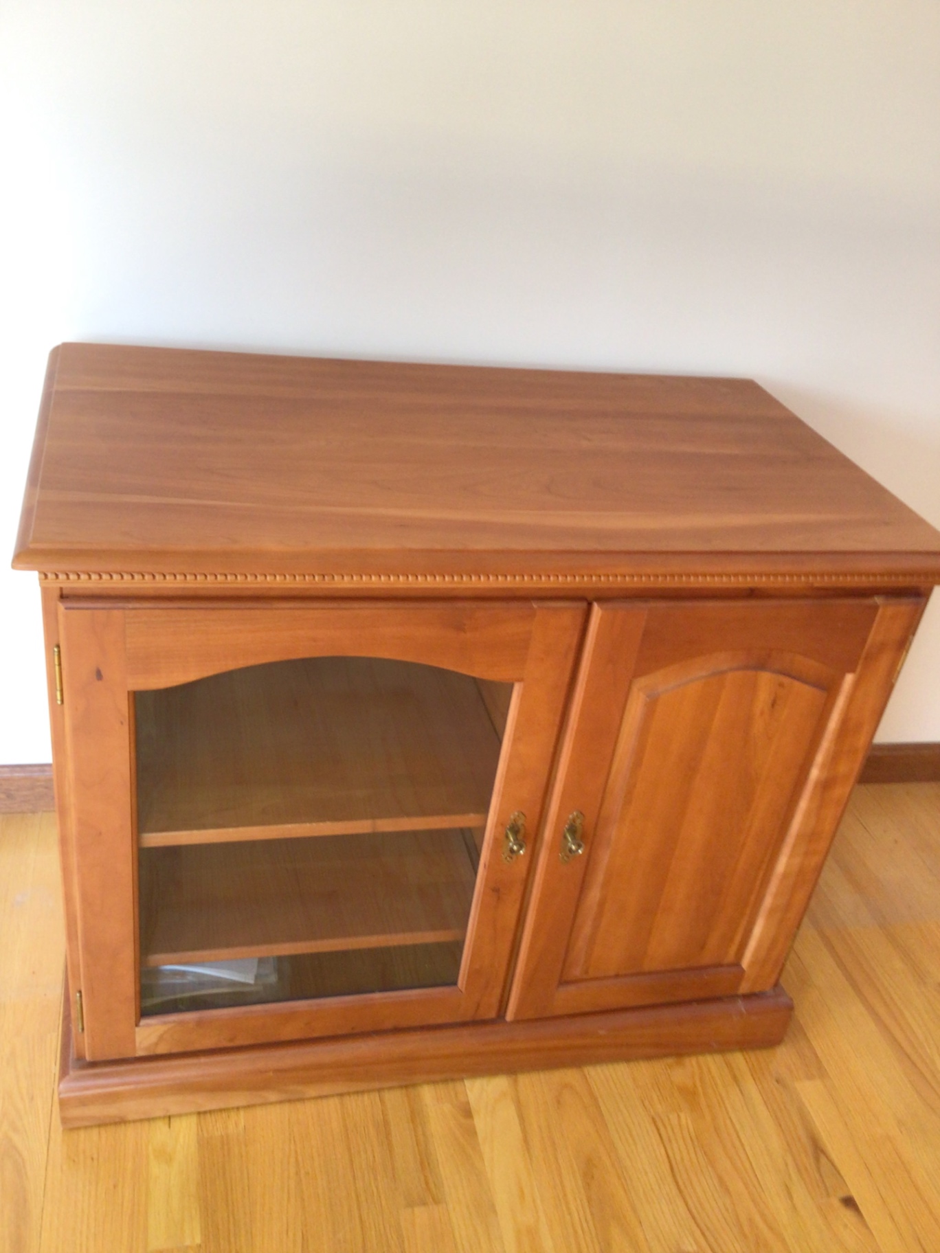 Wooden cabinet with glass-front left compartment and solid right door - image 1 of 3