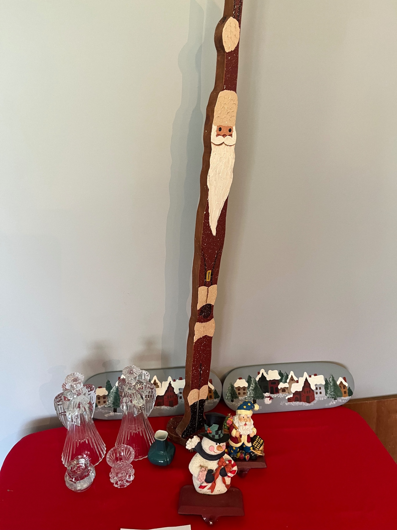 Tall carved Santa figure with Christmas village decor and crystal glassware - image 1 of 1