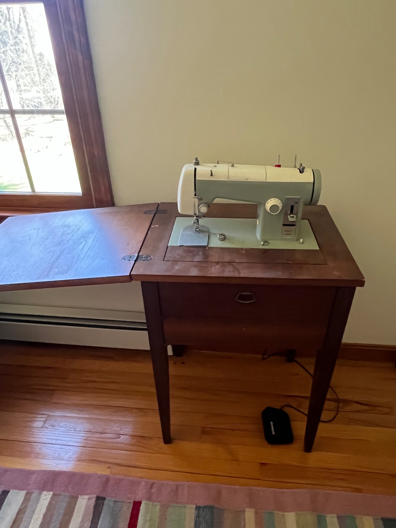 Vintage sewing machine on wooden table  - Sears Kenmore - image 1 of 2