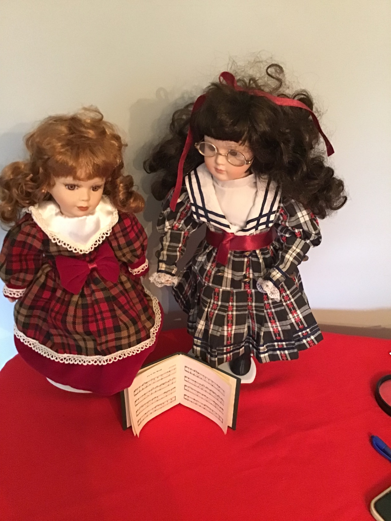 Two caroler dolls in plaid dresses with an open music book - image 1 of 2