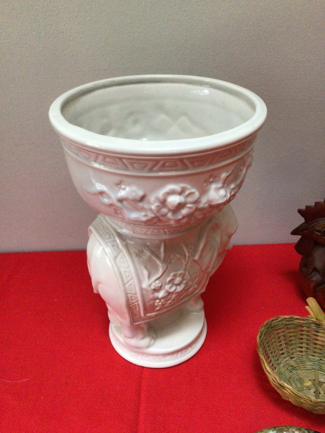 Decorative ceramic planter with floral relief, wooden rooster, wicker basket, and ceramic plate - image 2 of 2
