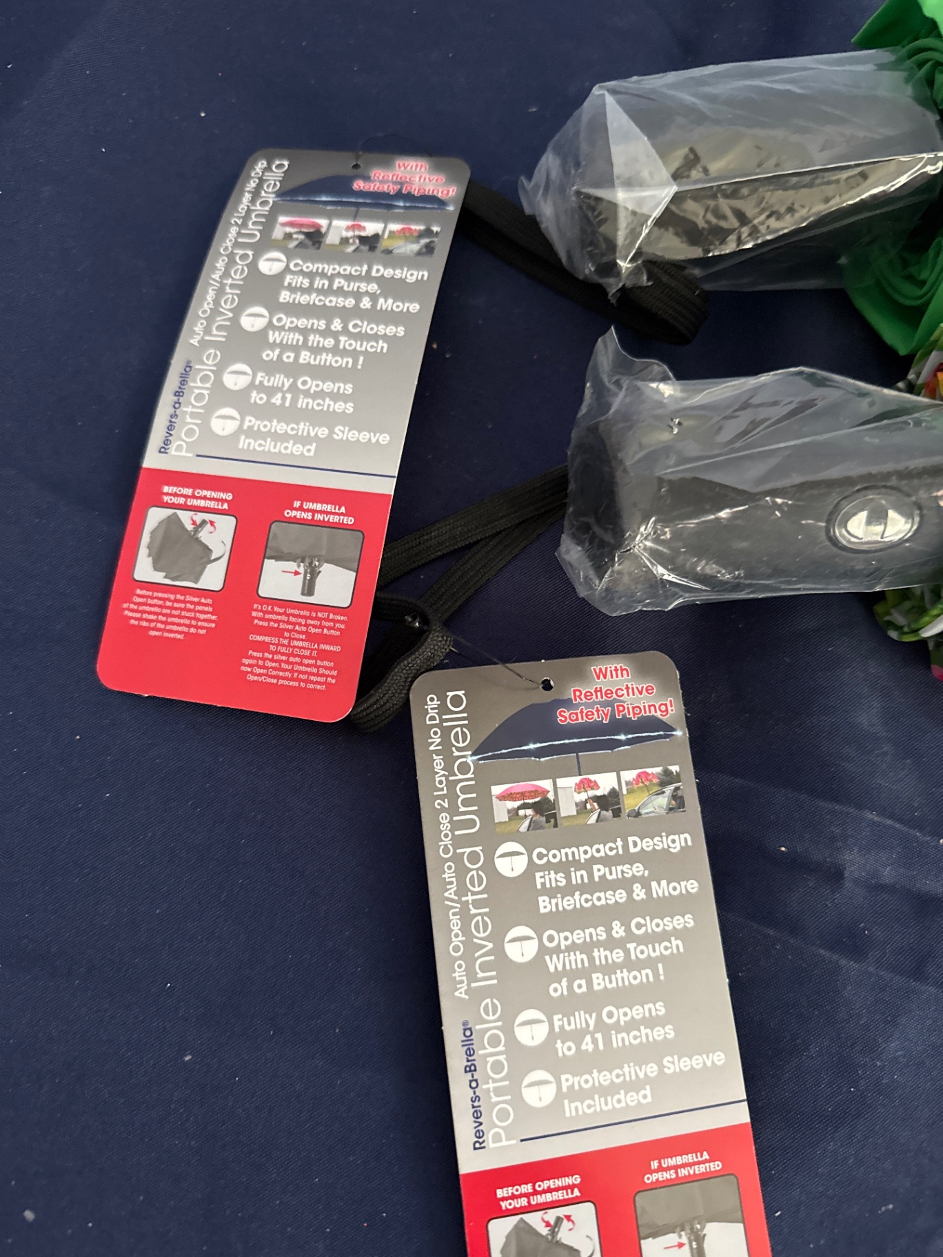Two compact inverted umbrellas with protective sleeves - image 2 of 2
