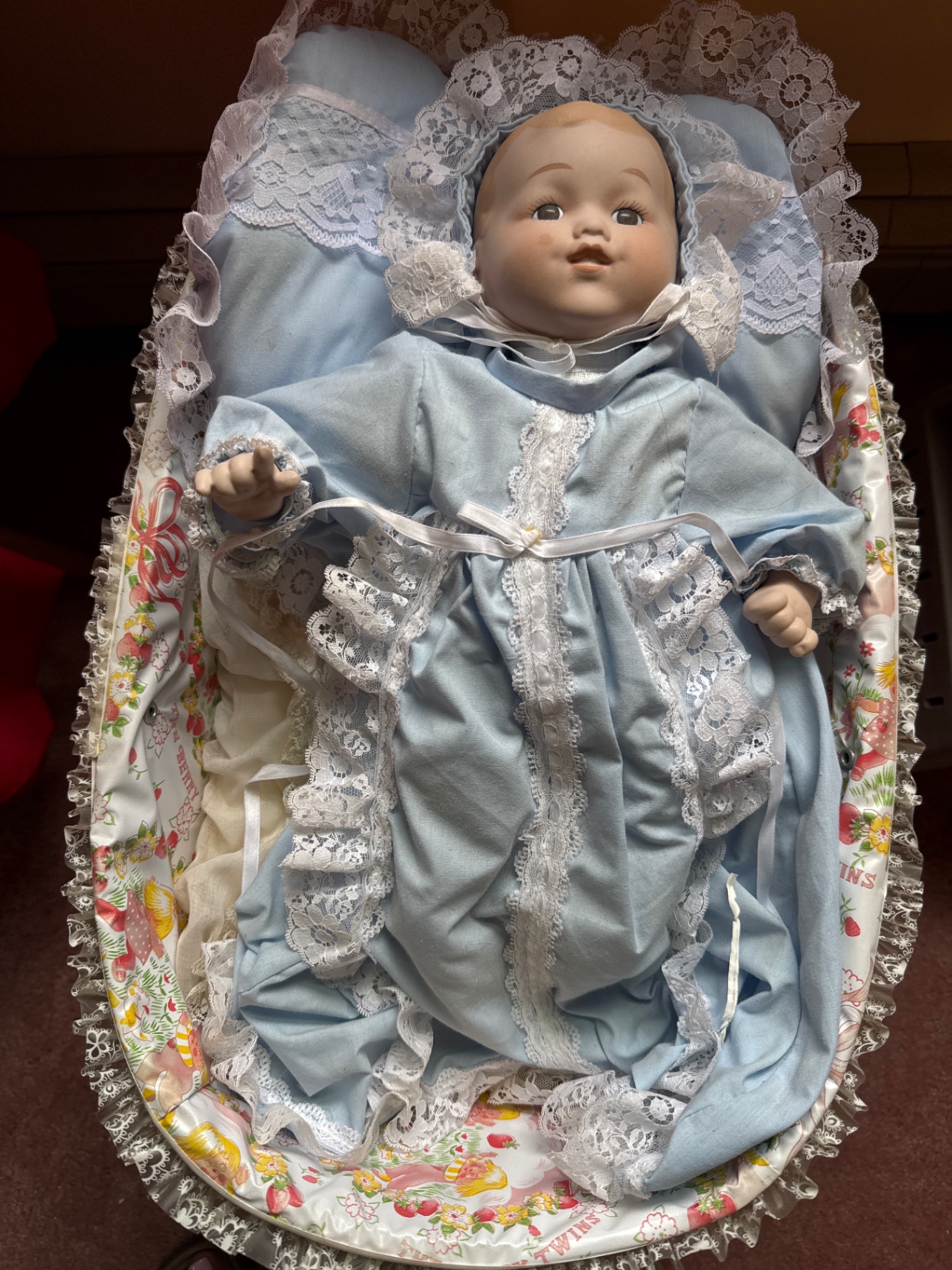 Porcelain baby doll in blue lace-trimmed gown in wicker cradle - image 2 of 6