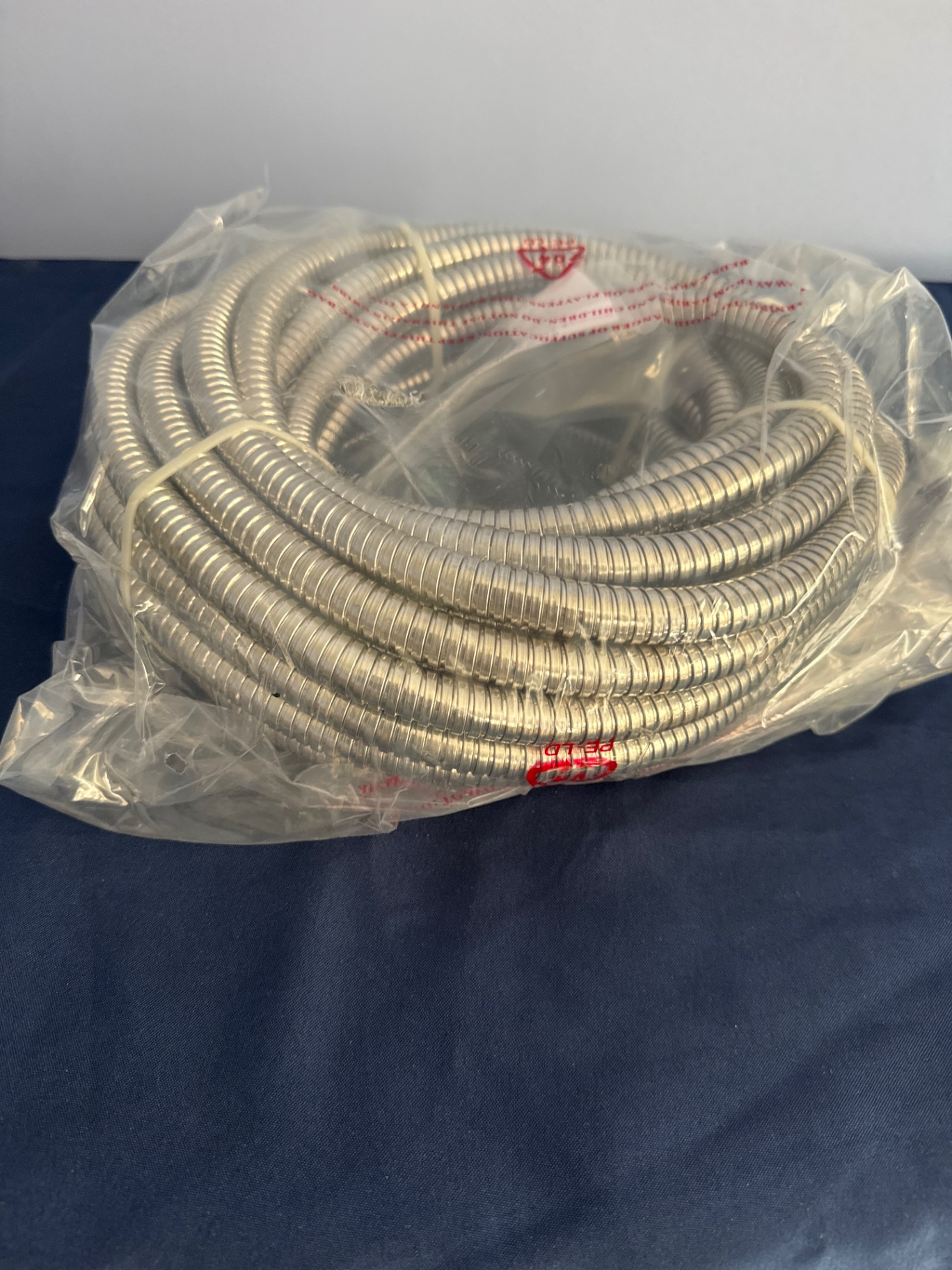 Coiled flexible metal hose and garden hands - image 1 of 3